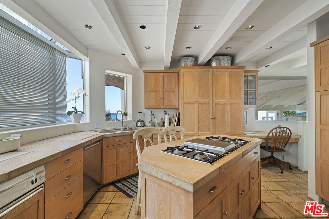31725 Sea Level Drive Malibu, CA 90265 - Photo 14 of 37 a kitchen with a sink stove and cabinets