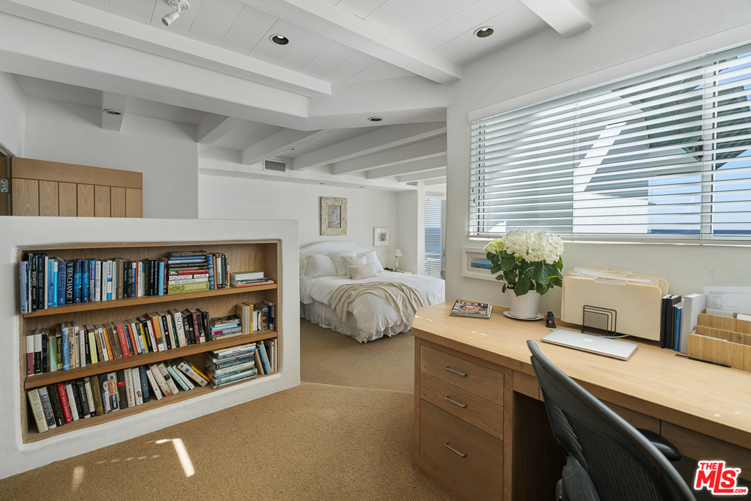 31725 Sea Level Drive Malibu, CA 90265 - Photo 21 of 37 a bedroom with furniture and a book shelf