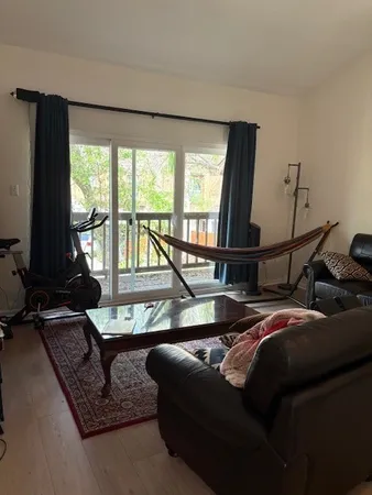 a living room with furniture and a floor to ceiling window