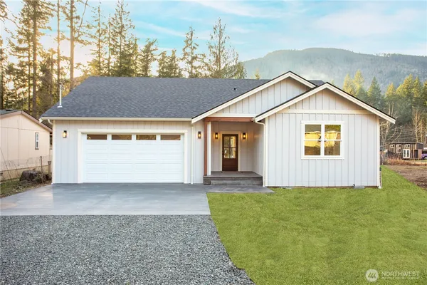 a front view of a house with a yard and garage