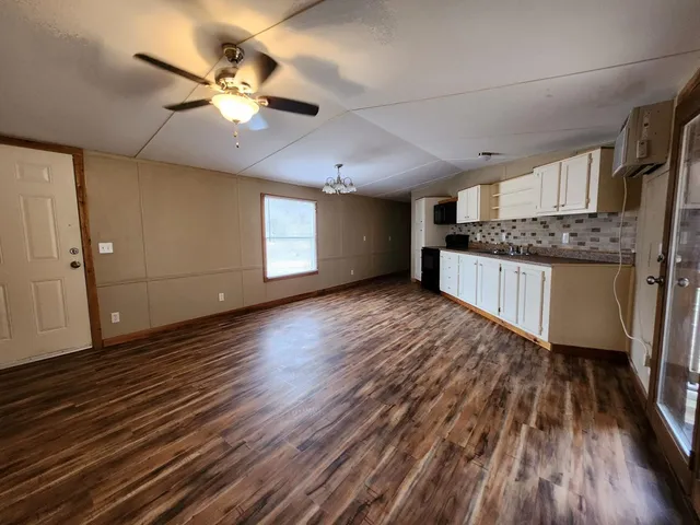 a kitchen with cabinets and a wooden floor