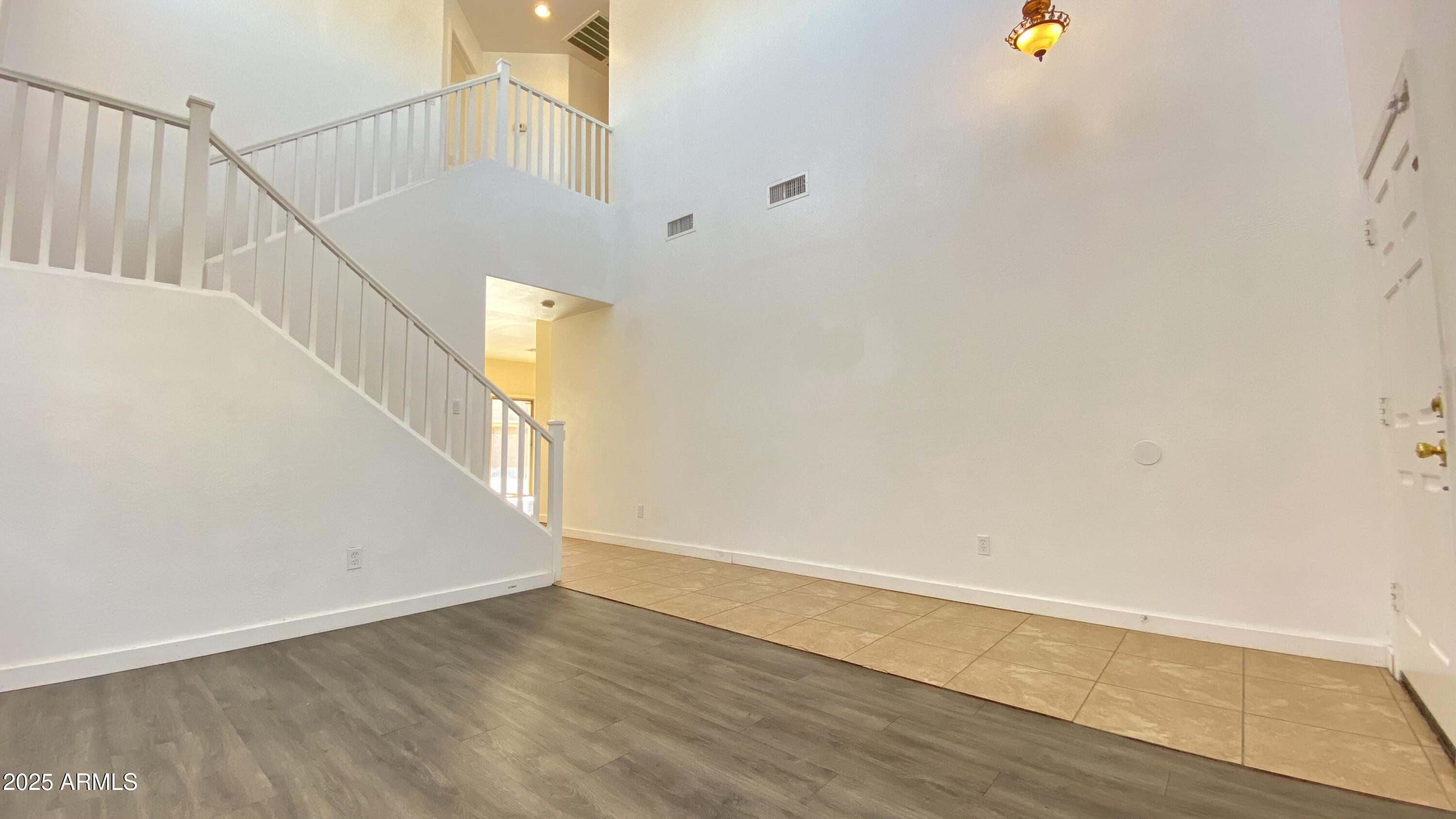 7425 West Crown King Road Phoenix, AZ 85043 - Photo 5 of 27 a view of a hallway with wooden floor and staircase