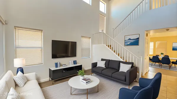 a living room with furniture a rug and a flat screen tv