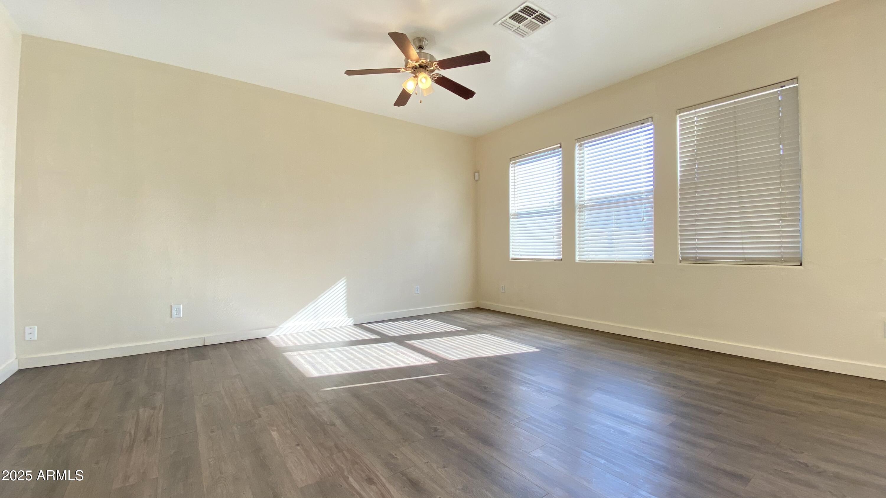7425 West Crown King Road Phoenix, AZ 85043 - Photo 6 of 27 an empty room with wooden floor and windows