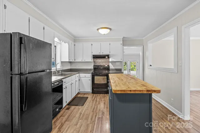 a kitchen with kitchen island granite countertop appliances cabinets and a counter space