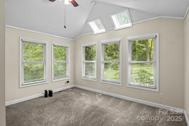 a view of an empty room with a window