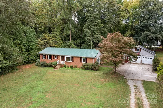 a house that has a tree in front of it
