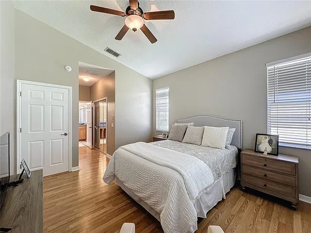 a bedroom with a bed and a chandelier