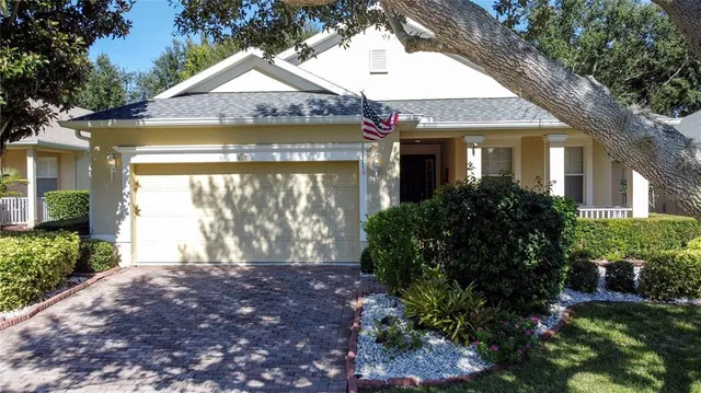 a front view of house with yard and trees around