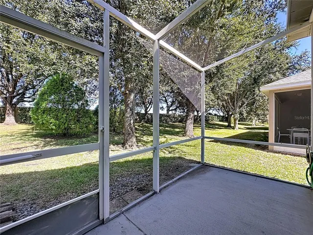 an aerial view of residential houses with outdoor space and lake view