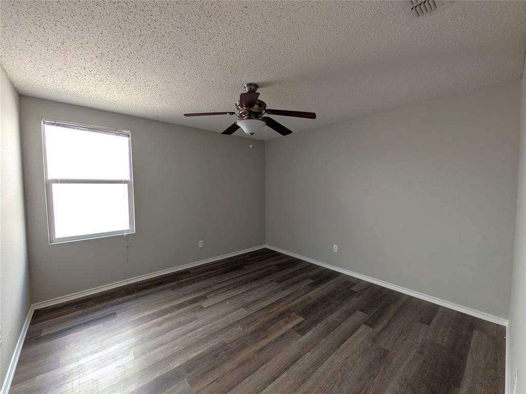 1736 Carolina Ridge Way Fort Worth, TX 76247 - Photo 21 of 33 Room featuring wood-finish flooring, a ceiling fan with integrated lighting, and a window with blinds
