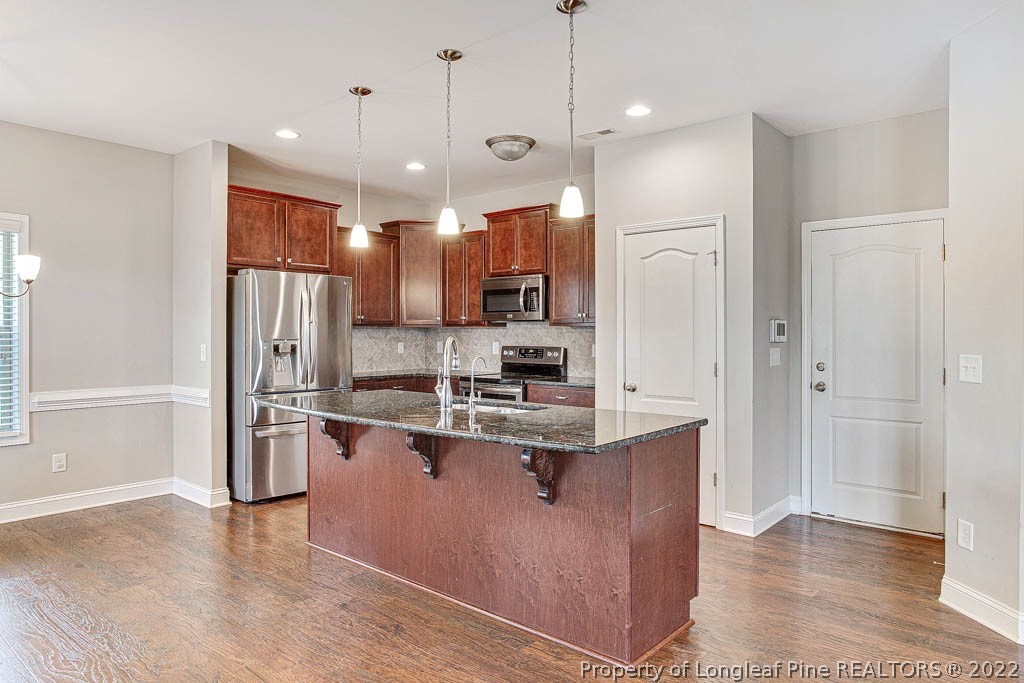 268 Turriff Way Cameron, NC 28326 - Photo 13 of 44 a kitchen with stainless steel appliances granite countertop a refrigerator a sink a stove and a refrigerator