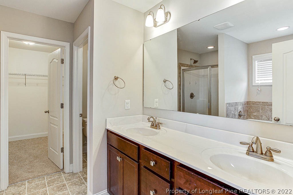 268 Turriff Way Cameron, NC 28326 - Photo 22 of 44 a bathroom with a sink double vanity and a mirror