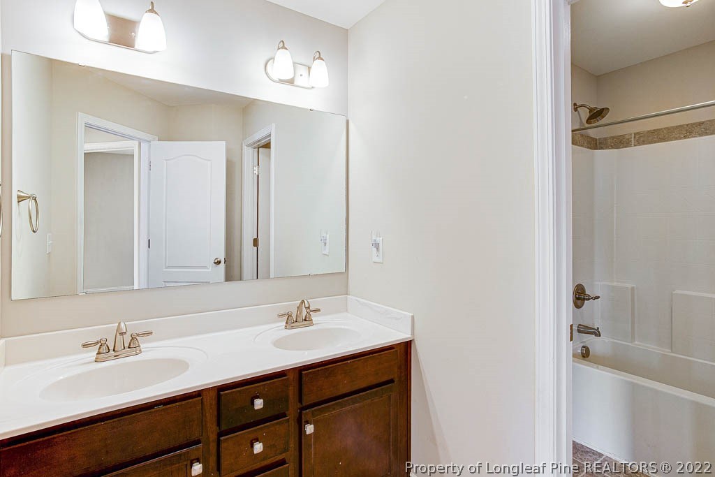 268 Turriff Way Cameron, NC 28326 - Photo 30 of 44 a bathroom with a tub sink double vanity and a mirror