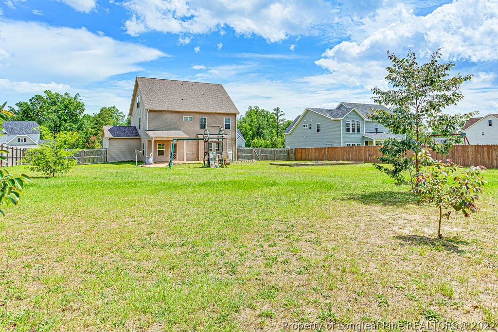 268 Turriff Way Cameron, NC 28326 - Photo 40 of 44 a view of a house with a big yard and large trees