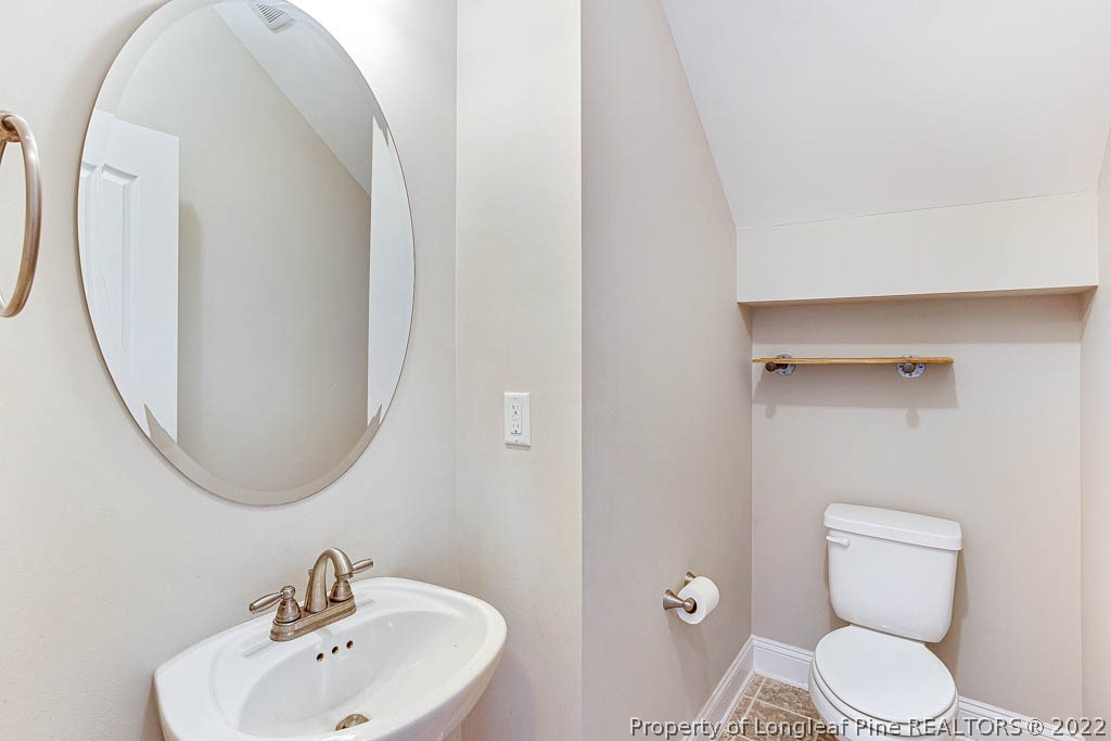 268 Turriff Way Cameron, NC 28326 - Photo 8 of 44 a bathroom with a toilet sink and mirror