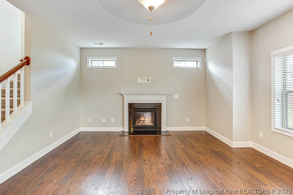 268 Turriff Way Cameron, NC 28326 - Photo 10 of 44 a view of an empty room with a window and wooden floor