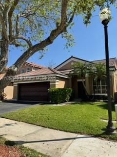 959 Falling Water Road Weston, FL 33326 - Photo 3 of 24 a view of a house with backyard and garden
