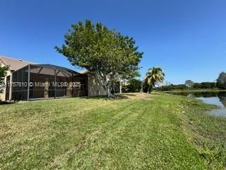 959 Falling Water Road Weston, FL 33326 - Photo 6 of 24 a front view of a house with a yard