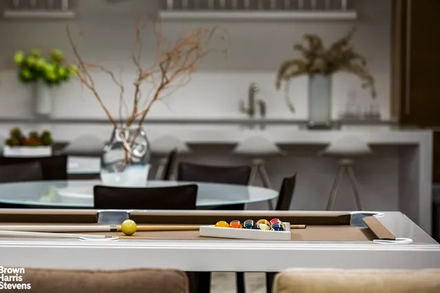 a vase of flowers sitting on a table with a potted plant