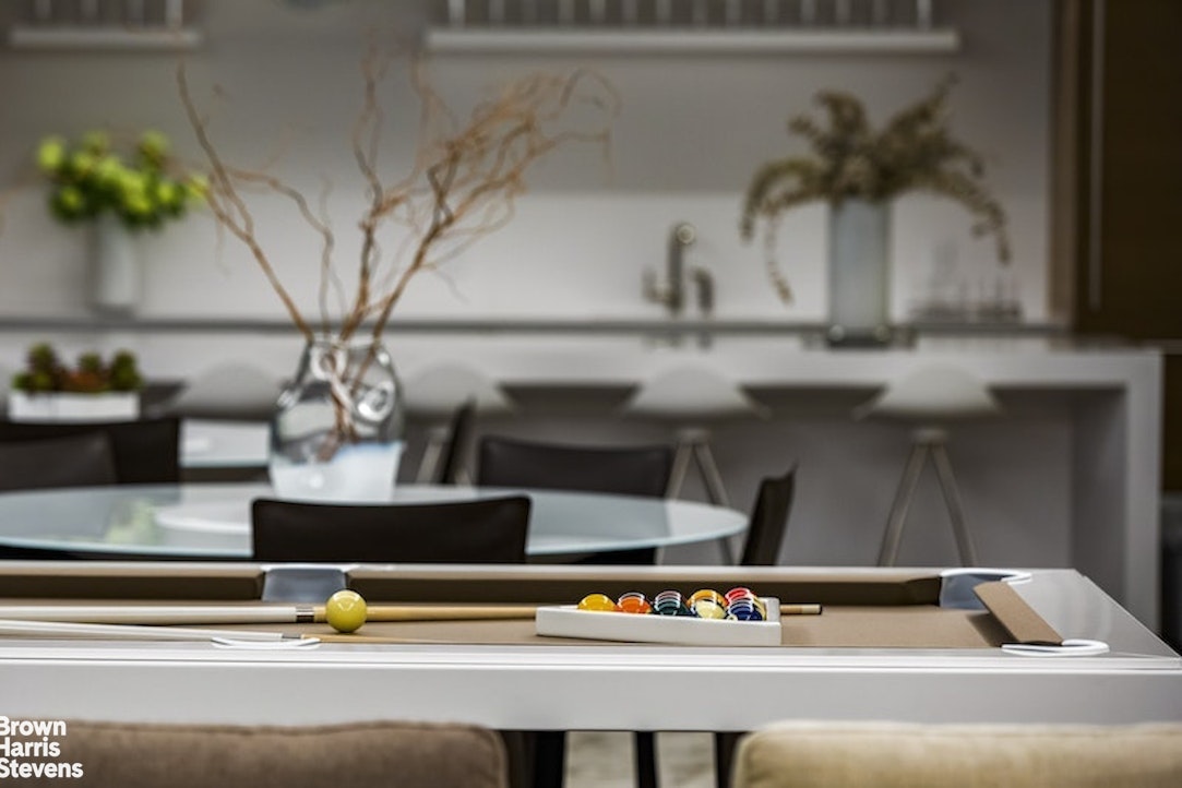 1289 Lexington Avenue, Unit PHA Manhattan, NY 10028 - Photo 19 of 21 a vase of flowers sitting on a table with a potted plant