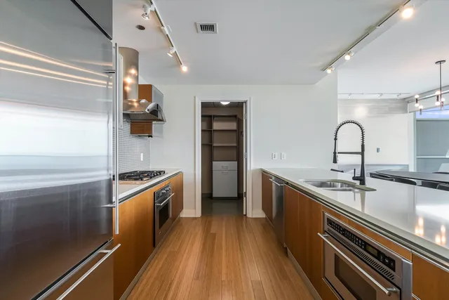 a kitchen with stainless steel appliances granite countertop a sink and a stove