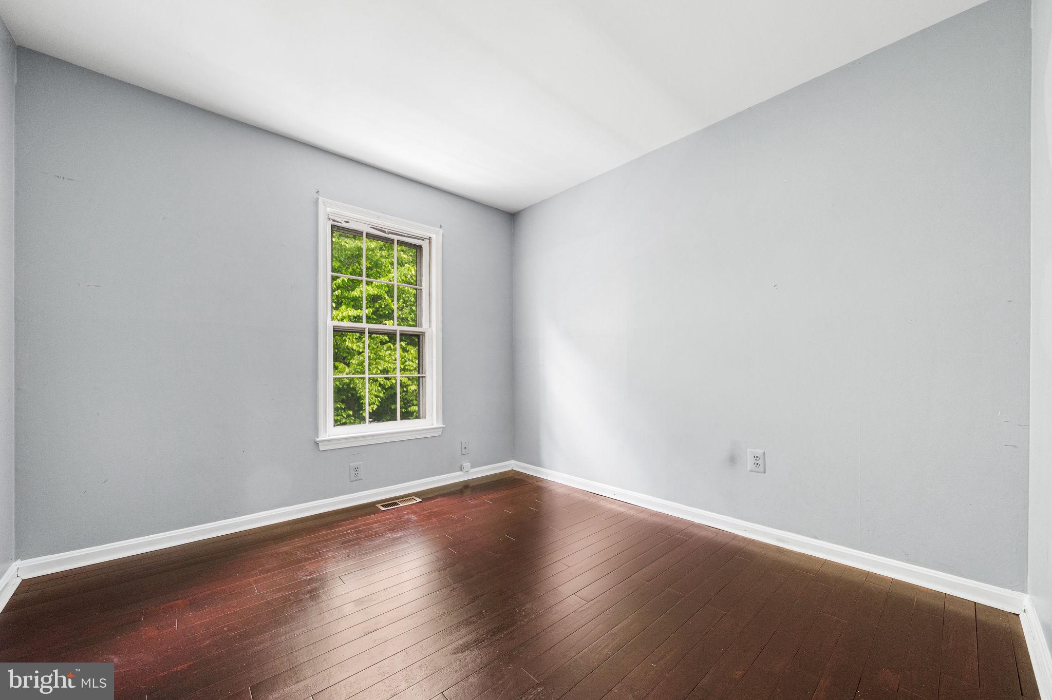 7403 Ridge Oak Court Springfield, VA 22153 - Photo 33 of 54 an empty room with wooden floor and windows