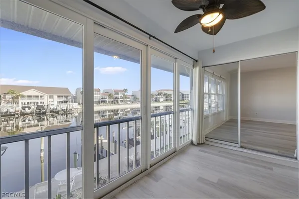 a view of a room with wooden floor and windows