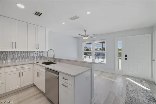 a kitchen with a sink stove and cabinets