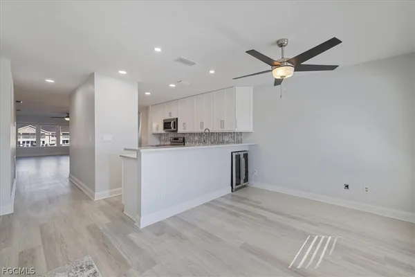 a view of a kitchen with a sink and a refrigerator