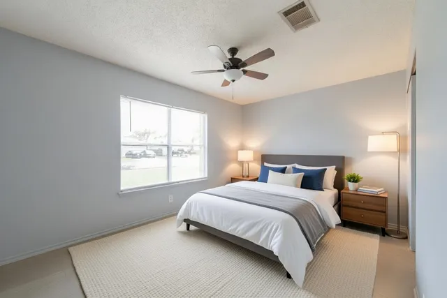 a bedroom with a large bed and a window