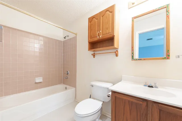 a bathroom with a sink a toilet and bathtub