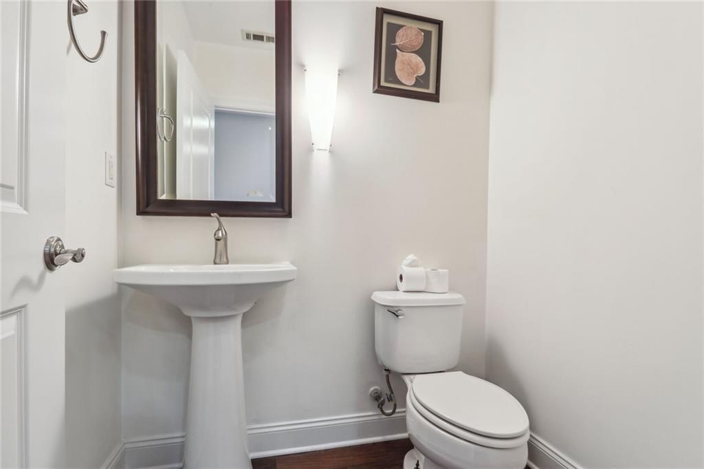 270 17th Street Northwest Atlanta, GA 30363 - Photo 12 of 15 a bathroom with a toilet sink vanity and mirror