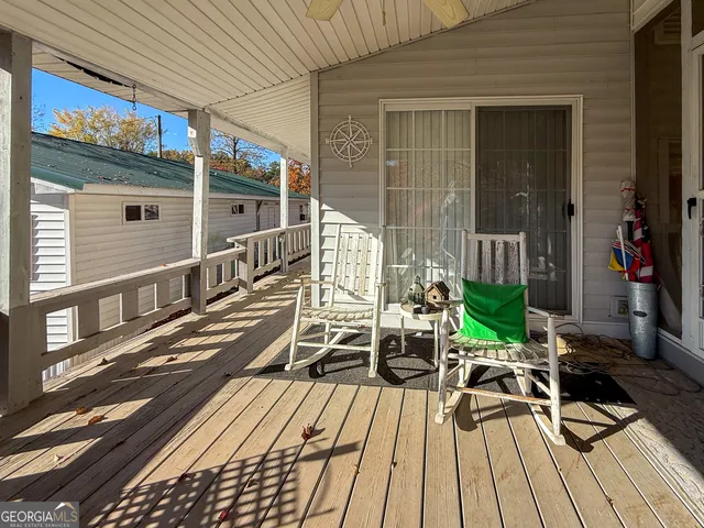 a view of balcony with chairs and wooden floor