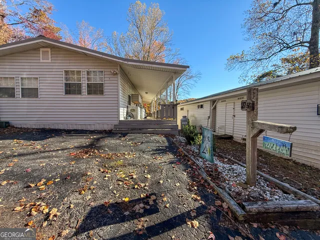 a view of a house with backyard and sitting area