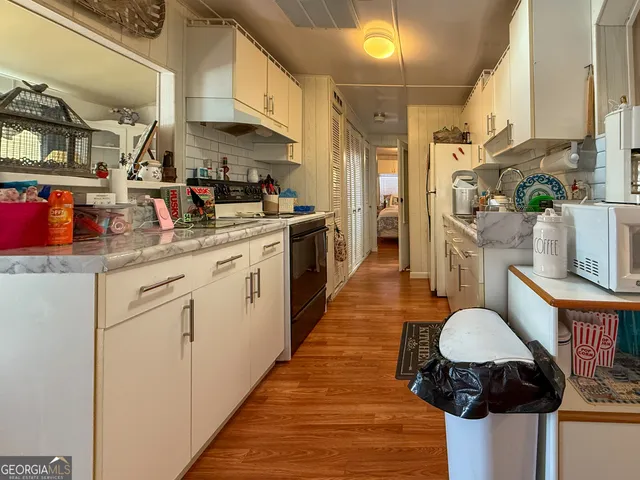 a kitchen with a sink cabinets and a table