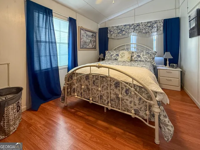 a bed sitting in a bedroom next to a window