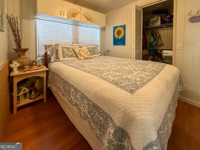 a bed sitting in a bedroom next to a window