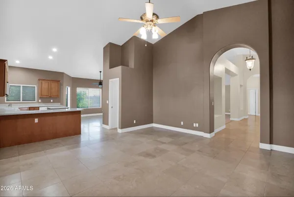 a bathroom with a granite countertop bathtub sink vanity mirror and toilet