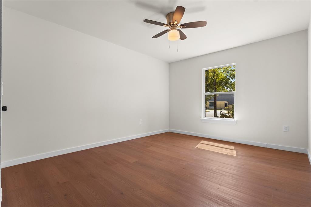 513 East Union Bower Road Irving, TX 75061 - Photo 18 of 34 Wood-finish flooring with white baseboards, a single window, and a ceiling fan with integrated lighting
