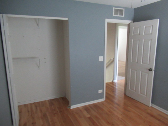 508 Ramsden Road Plano, IL 60545 - Photo 13 of 31 a view of an empty room with wooden floor and a window