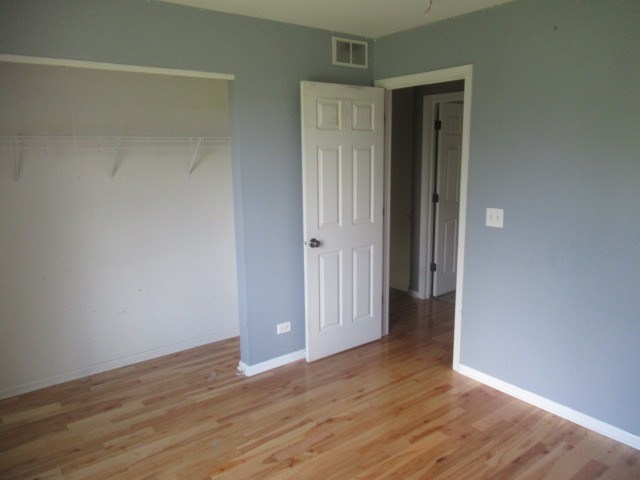 508 Ramsden Road Plano, IL 60545 - Photo 22 of 31 a view of an empty room with wooden floor