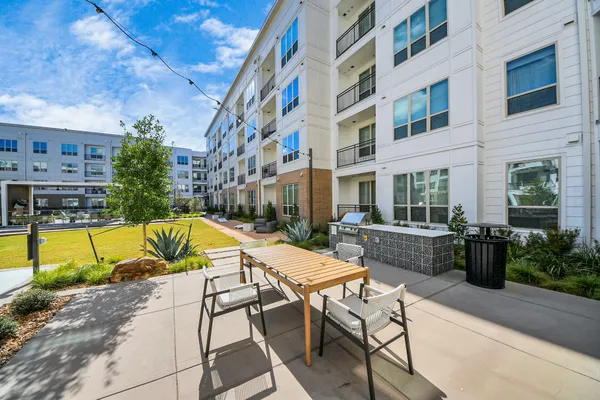 a bathroom with a double vanity sink toilet mirror and shower