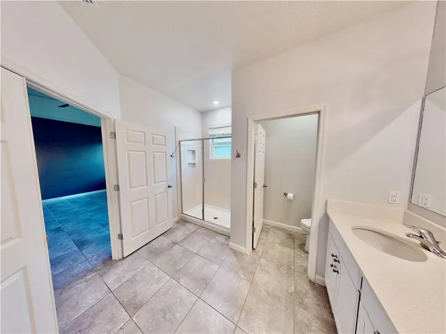 a spacious bathroom with a double vanity sink a mirror and a shower