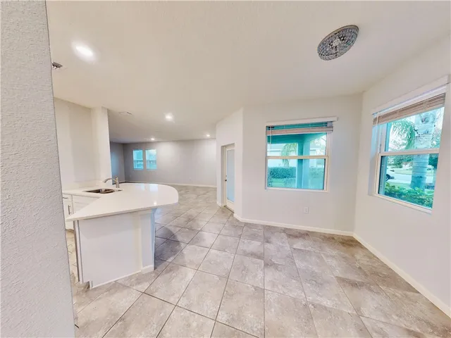 a view of a kitchen with a sink and a window
