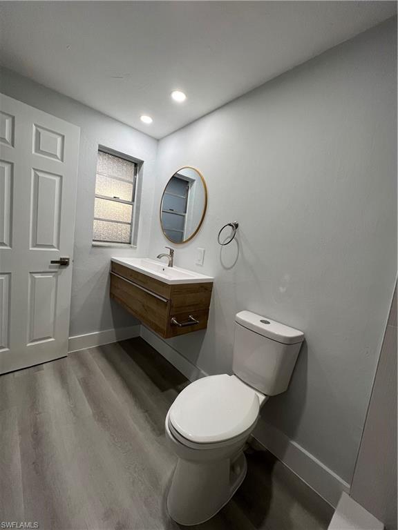 5345 Hardee Street Naples, FL 34113 - Photo 12 of 20 a bathroom with a toilet a sink and mirror