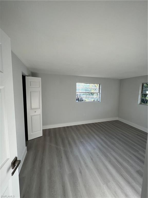 5345 Hardee Street Naples, FL 34113 - Photo 13 of 20 an empty room with wooden floor and windows