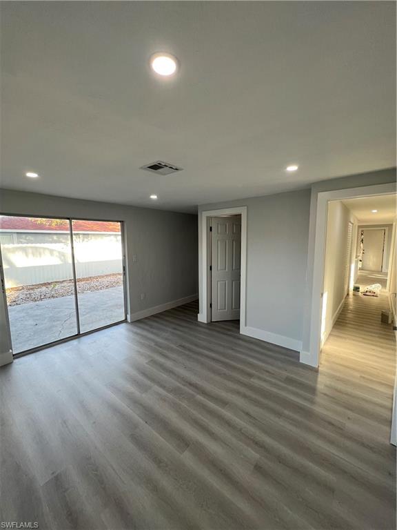 5345 Hardee Street Naples, FL 34113 - Photo 16 of 20 an empty room with wooden floor and glass door
