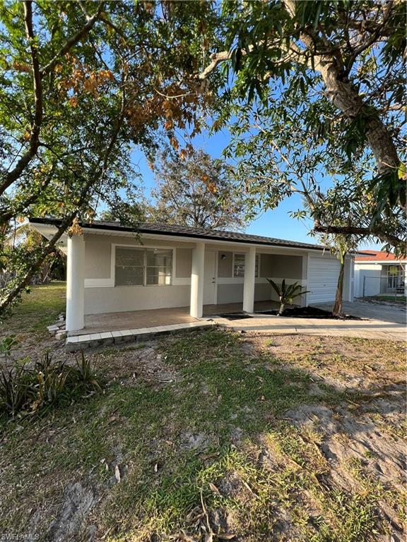 5345 Hardee Street Naples, FL 34113 - Photo 2 of 20 a front view of a house with a garden