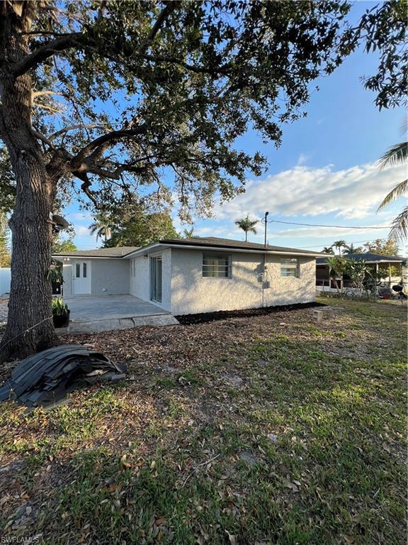 5345 Hardee Street Naples, FL 34113 - Photo 3 of 20 a front view of a house with a yard